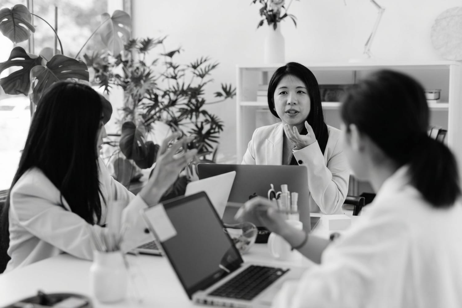 Three women in conversation around a table