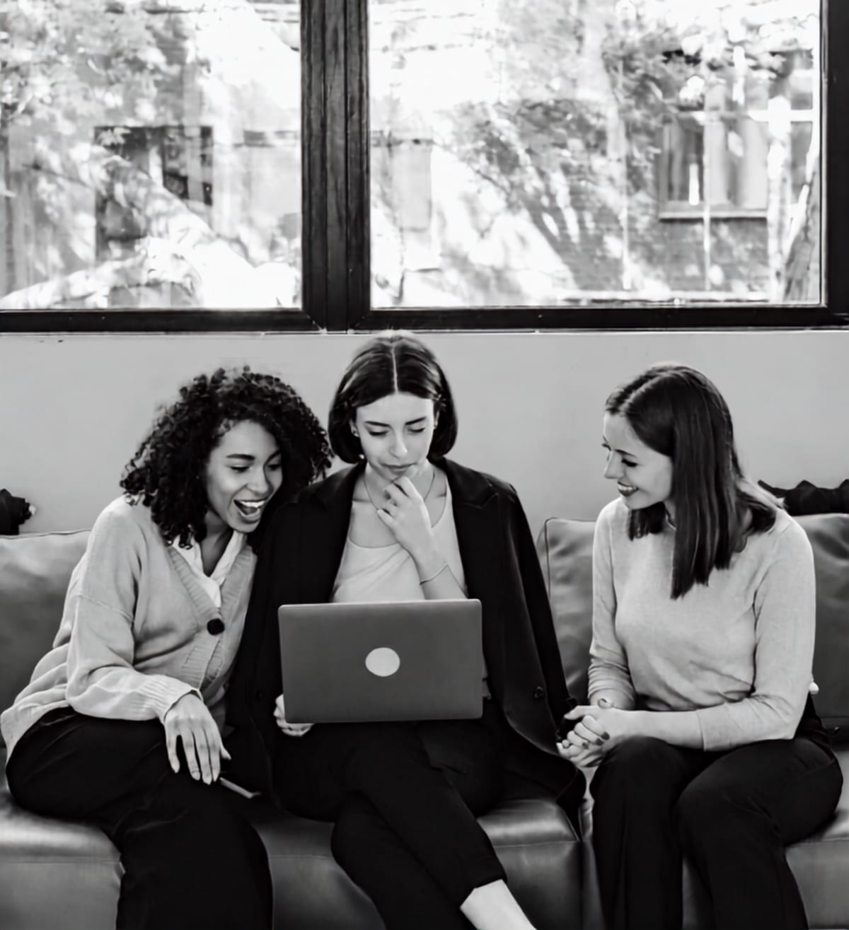 A group of women working together on a laptop