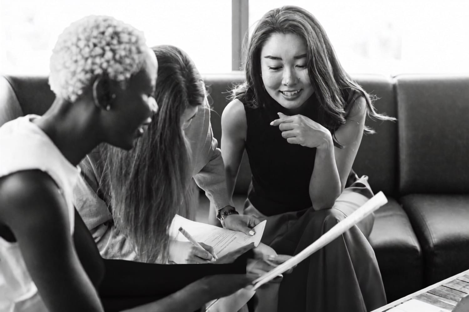 Three women reviewing a document together